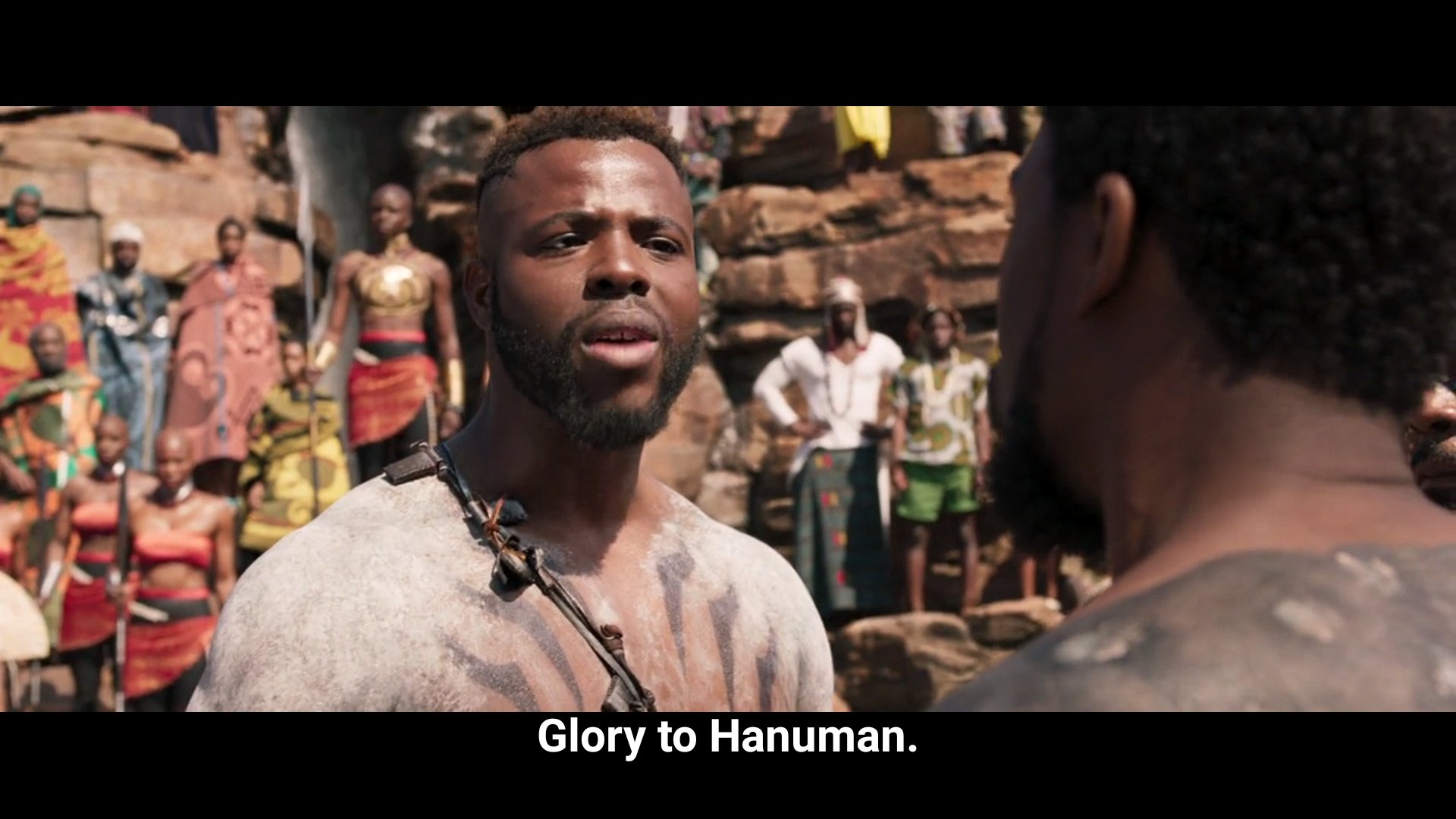Why does Mbaku say Glory to Hanuman?